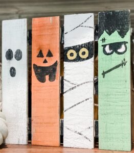Four Halloween characters painted on boards