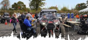 Wheelchair user loading into off-road vehicle at Disability Dirt Days