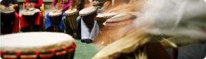 Group seated in a circle participating in therapeutic drumming session