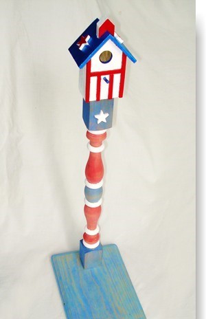 A red white and blue bird house with stars on it.