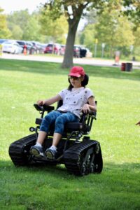 Young girl using a tracked wheelchair