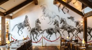 Interior white wall with painted black horses at White Horse Inn